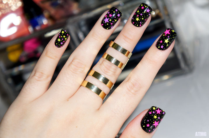 unha preta com estrelas coloridas